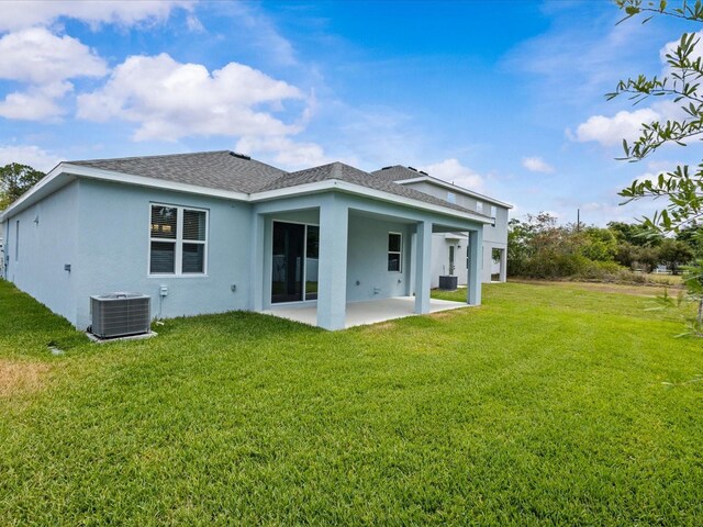 8018 Colby Cir, Orlando, FL 32817 - back of house featuring central AC, a patio, stucco siding, and a lawn