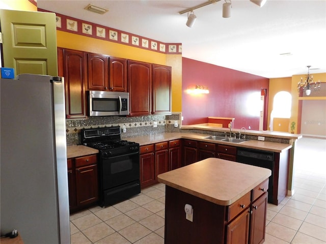 7045 Branch Ct, Saint Cloud, FL 34771 - kitchen with black appliances, a sink, a peninsula, light tile patterned flooring, and backsplash