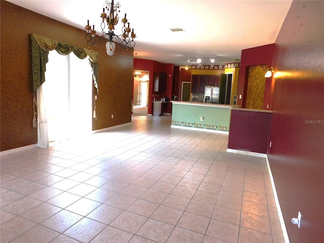 7045 Branch Ct, Saint Cloud, FL 34771 - kitchen featuring stainless steel refrigerator with ice dispenser, light tile patterned floors, a chandelier, and open floor plan