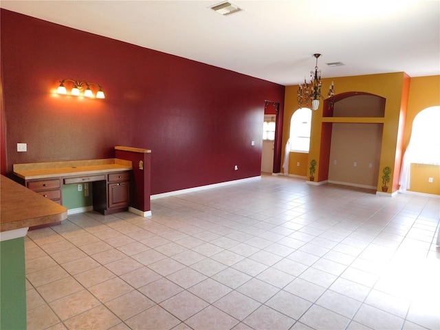 7045 Branch Ct, Saint Cloud, FL 34771 - empty room with a chandelier, light tile patterned floors, and baseboards