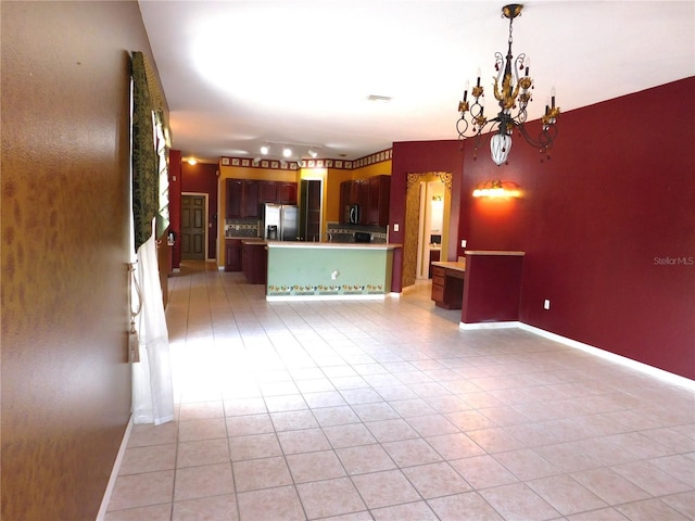 7045 Branch Ct, Saint Cloud, FL 34771 - unfurnished living room featuring light tile patterned flooring, a chandelier, and baseboards