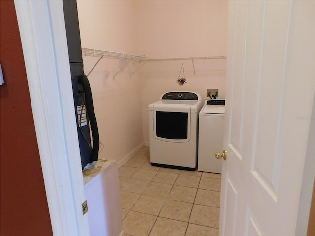 7045 Branch Ct, Saint Cloud, FL 34771 - laundry area with washer and clothes dryer and light tile patterned floors