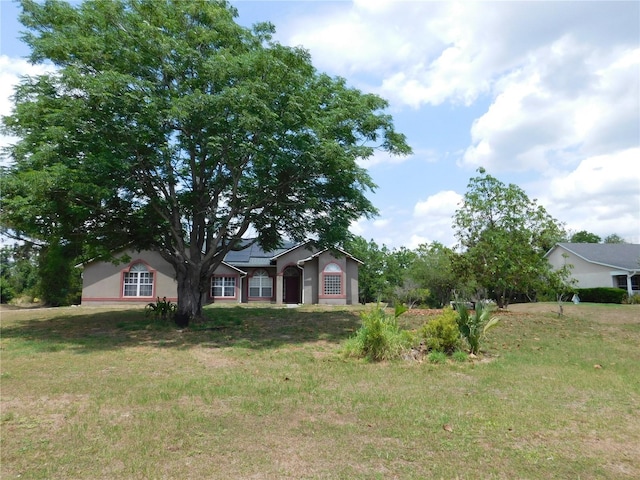 7045 Branch Ct, Saint Cloud, FL 34771 - view of front of home featuring stucco siding and a front yard