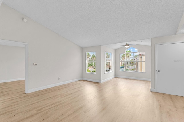 2213 Grand Cayman Ct Unit 1138, Kissimmee, FL 34741 - unfurnished living room with lofted ceiling, ceiling fan, light wood finished floors, a textured ceiling, and baseboards