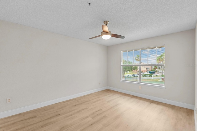 2213 Grand Cayman Ct Unit 1138, Kissimmee, FL 34741 - empty room with light wood-style floors, baseboards, a ceiling fan, fire sprinkler in ceiling, and a textured ceiling