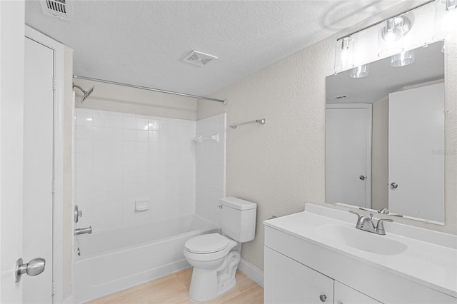 2213 Grand Cayman Ct Unit 1138, Kissimmee, FL 34741 - full bathroom with a textured ceiling, toilet, wood finished floors, vanity, and a textured wall