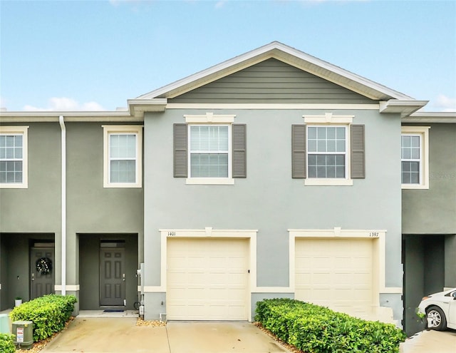 1401 Yellow Finch Dr, Davenport, FL 33837 - multi unit property featuring an attached garage, stucco siding, and concrete driveway