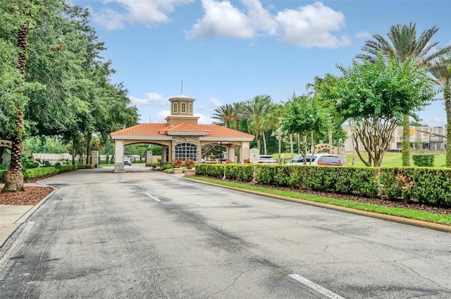 1401 Yellow Finch Dr, Davenport, FL 33837 - view of asphalt street featuring curbs and a gated entry