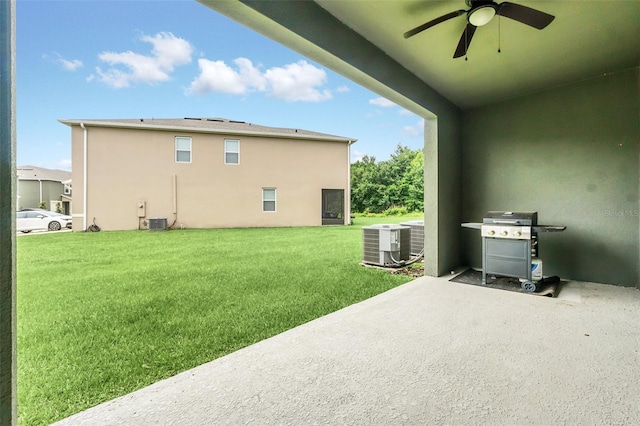1401 Yellow Finch Dr, Davenport, FL 33837 - view of green lawn with ceiling fan, a patio, and central air condition unit