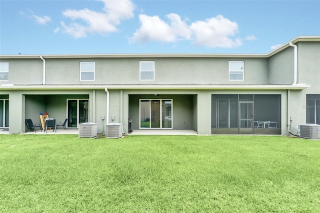 1401 Yellow Finch Dr, Davenport, FL 33837 - rear view of property with stucco siding, central air condition unit, a lawn, and a patio