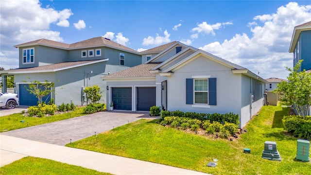2591 Seagirt Way, Clermont, FL 34711 - traditional-style home featuring stucco siding, an attached garage, a front lawn, and decorative driveway