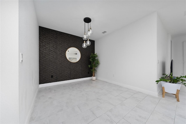 2591 Seagirt Way, Clermont, FL 34711 - spare room featuring an accent wall, wallpapered walls, and baseboards