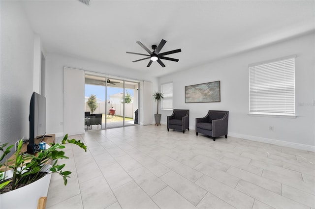 2591 Seagirt Way, Clermont, FL 34711 - living area featuring a ceiling fan and baseboards
