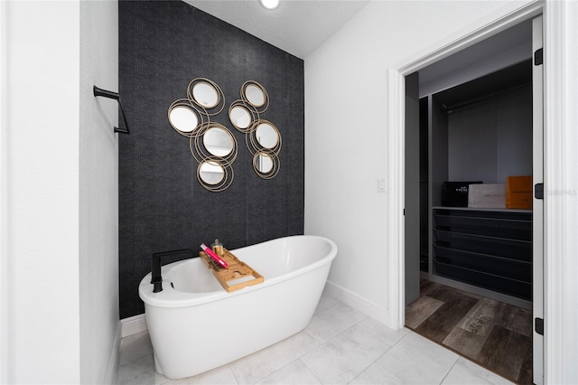 2591 Seagirt Way, Clermont, FL 34711 - full bathroom with a freestanding bath, baseboards, and an accent wall