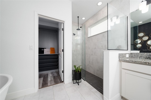 2591 Seagirt Way, Clermont, FL 34711 - full bathroom featuring a walk in shower, vanity, tile patterned floors, and baseboards