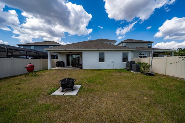 2591 Seagirt Way, Clermont, FL 34711 - rear view of house featuring a ceiling fan, an outdoor fire pit, a patio, stucco siding, and a shingled roof