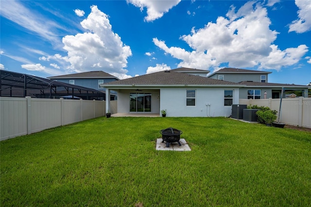 2591 Seagirt Way, Clermont, FL 34711 - rear view of house with an outdoor fire pit, stucco siding, a fenced backyard, and a ceiling fan