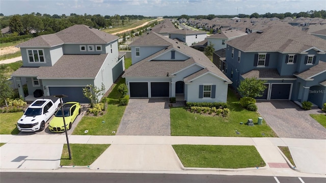 2591 Seagirt Way, Clermont, FL 34711 - view of front of property featuring decorative driveway, stucco siding, and a residential view
