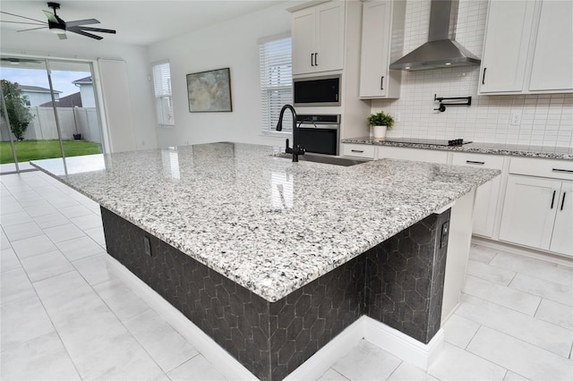 2591 Seagirt Way, Clermont, FL 34711 - kitchen featuring wall chimney range hood, stainless steel oven, a ceiling fan, and built in microwave