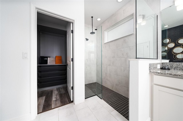 2591 Seagirt Way, Clermont, FL 34711 - full bath featuring walk in shower, vanity, a walk in closet, and tile patterned flooring