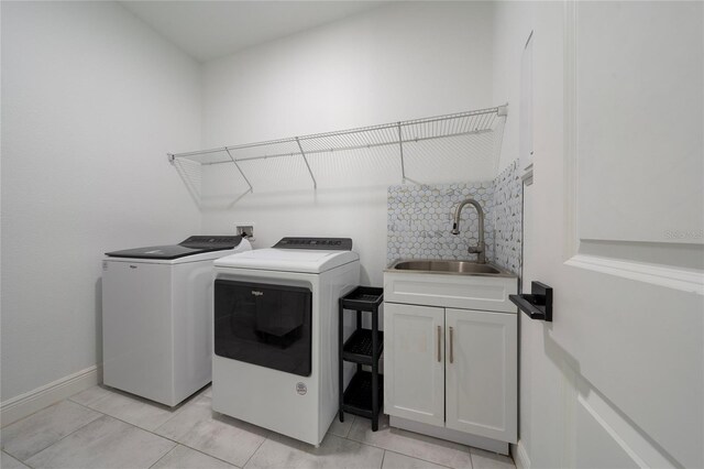 2591 Seagirt Way, Clermont, FL 34711 - washroom featuring cabinet space, washer and dryer, and light tile patterned floors