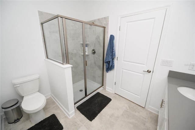 full bathroom with a shower stall, baseboards, tile patterned floors, and toilet
