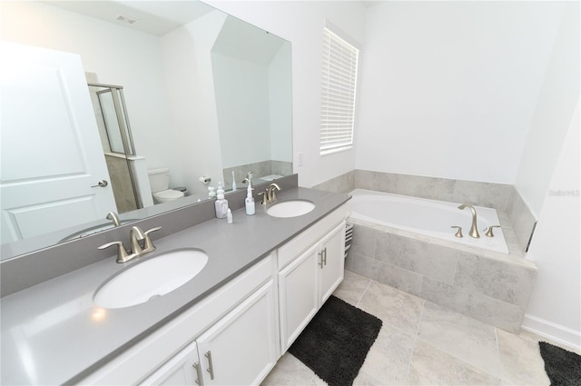 bathroom featuring a bath, toilet, double vanity, and a shower with shower door