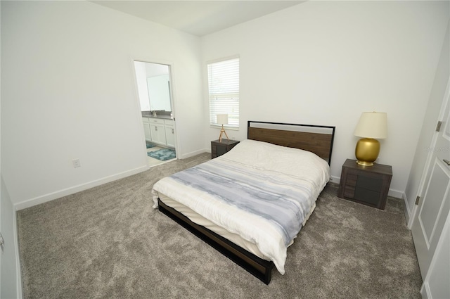 bedroom with carpet flooring, baseboards, and ensuite bath