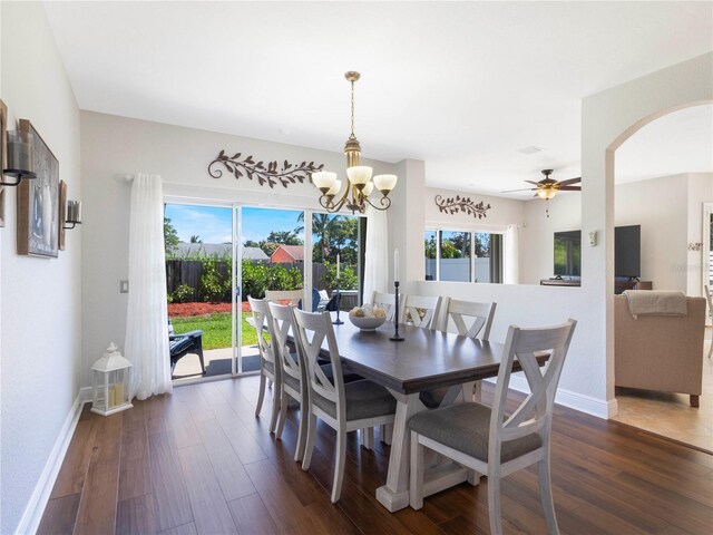 7580 Colony Palm Dr, Boynton Beach, FL 33436 - dining area featuring dark wood-style floors, arched walkways, baseboards, and a chandelier