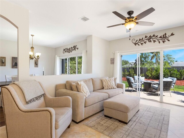 7580 Colony Palm Dr, Boynton Beach, FL 33436 - living room with healthy amount of natural light, a chandelier, ceiling fan, and light tile patterned floors