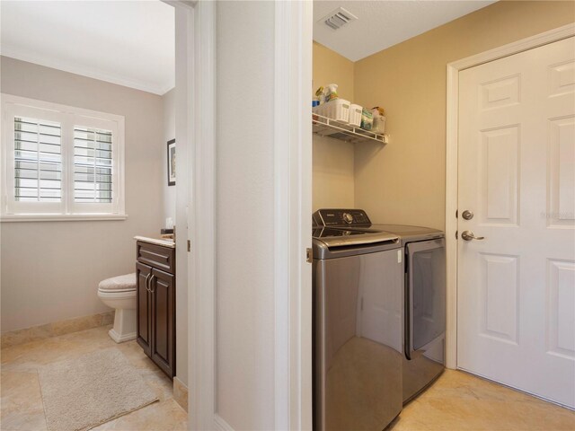 7580 Colony Palm Dr, Boynton Beach, FL 33436 - washroom with washing machine and dryer, baseboards, crown molding, and light tile patterned flooring