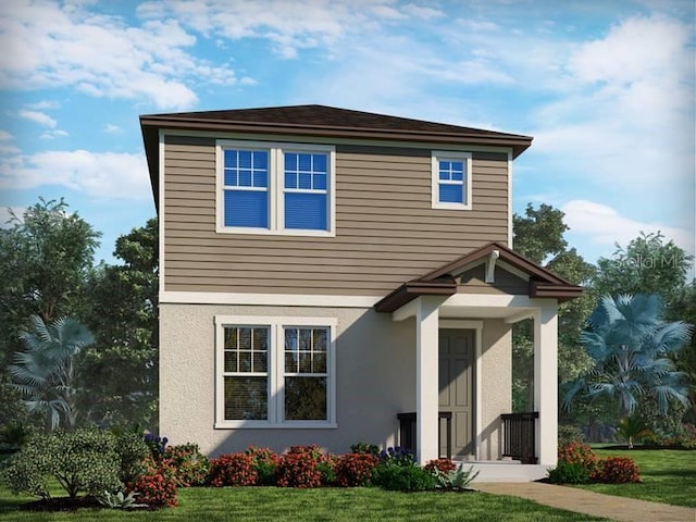 view of front of house featuring stucco siding and a front lawn