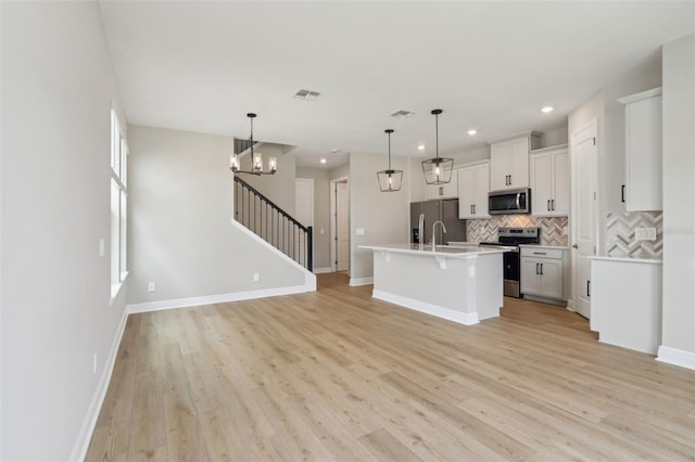 16460 Silver Brook Way, Winter Garden, FL 34787 - kitchen featuring stainless steel appliances, backsplash, a kitchen bar, light wood-style flooring, and recessed lighting