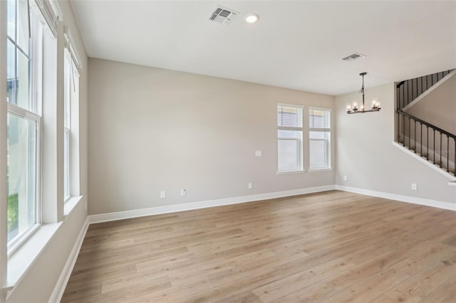 16460 Silver Brook Way, Winter Garden, FL 34787 - spare room with a chandelier, light wood-style floors, baseboards, and stairway