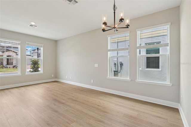 16460 Silver Brook Way, Winter Garden, FL 34787 - unfurnished dining area with a chandelier, light wood-style floors, and baseboards