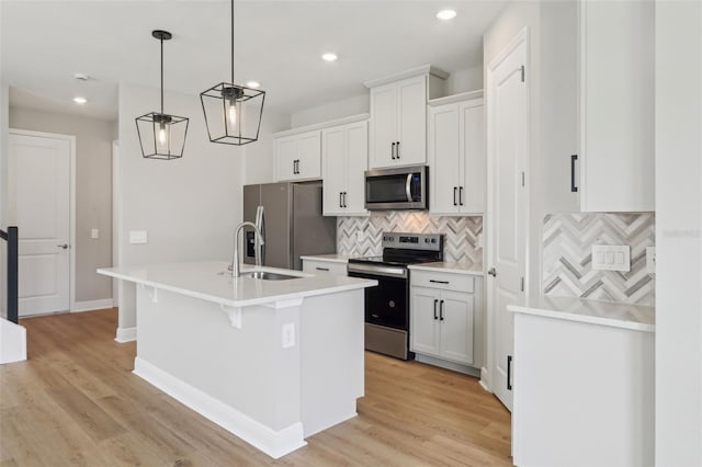 16460 Silver Brook Way, Winter Garden, FL 34787 - kitchen with appliances with stainless steel finishes, a sink, an island with sink, tasteful backsplash, and white cabinetry