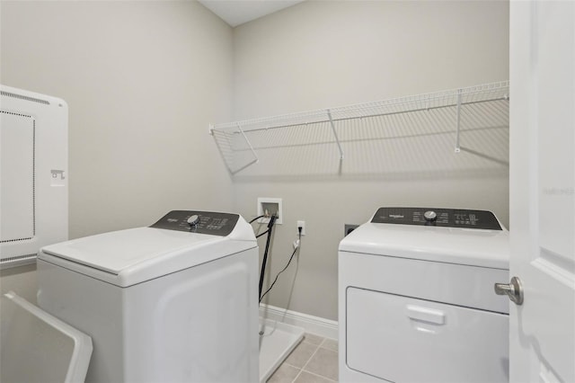16460 Silver Brook Way, Winter Garden, FL 34787 - washroom featuring washing machine and clothes dryer, light tile patterned flooring, and baseboards