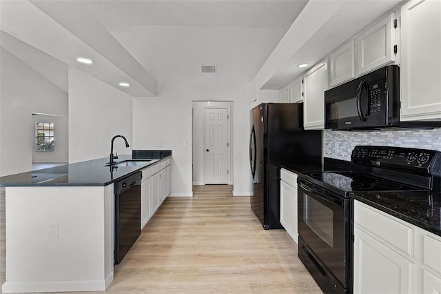 kitchen with black appliances, a sink, a peninsula, white cabinetry, and recessed lighting
