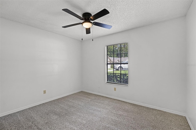 unfurnished room featuring a textured ceiling, carpet floors, ceiling fan, and baseboards