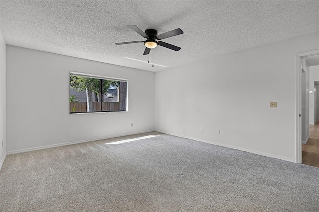 carpeted spare room with ceiling fan, a textured ceiling, and baseboards