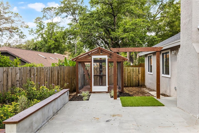 view of patio featuring a fenced backyard and an outdoor structure