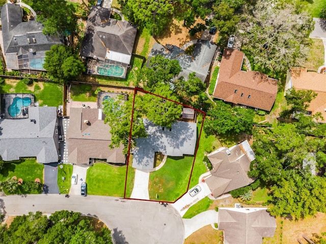 aerial view of residential area with property boundaries highlighted and a pool area
