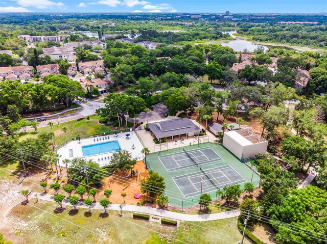 drone / aerial view of a pool and a large body of water