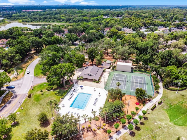 drone / aerial view of a pool and a nearby body of water