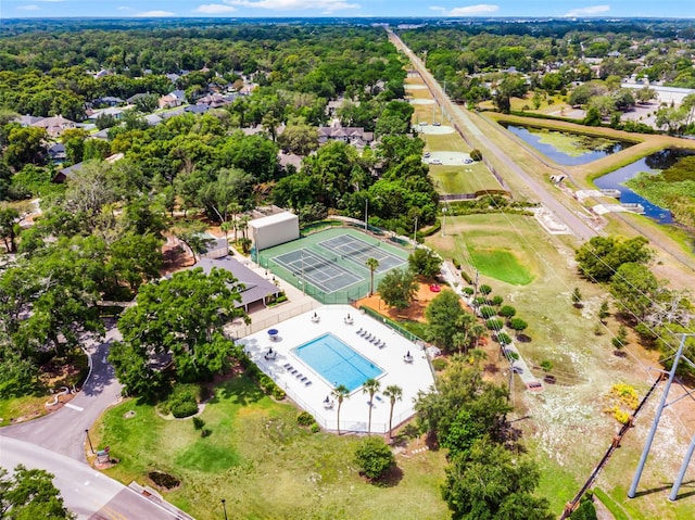 aerial view of a pool area and a nearby body of water
