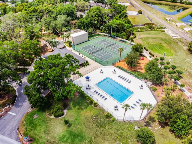 drone / aerial view of a pool and a large body of water