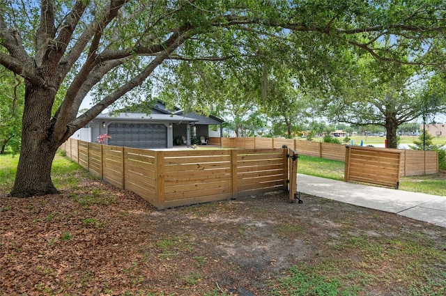 view of yard featuring a garage and fence