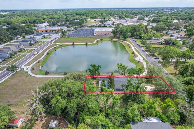 aerial view of residential area featuring property boundaries highlighted and a nearby body of water