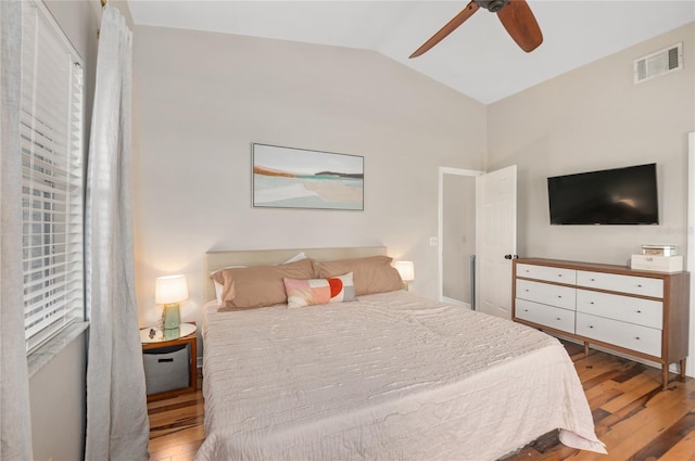 bedroom with vaulted ceiling, wood finished floors, and ceiling fan