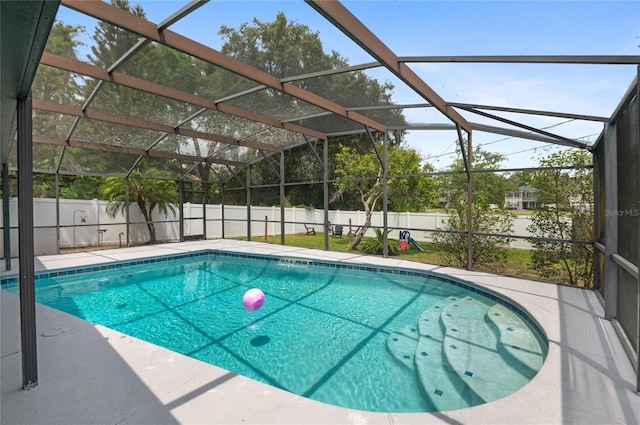 view of pool featuring a fenced backyard, a lanai, and a patio area